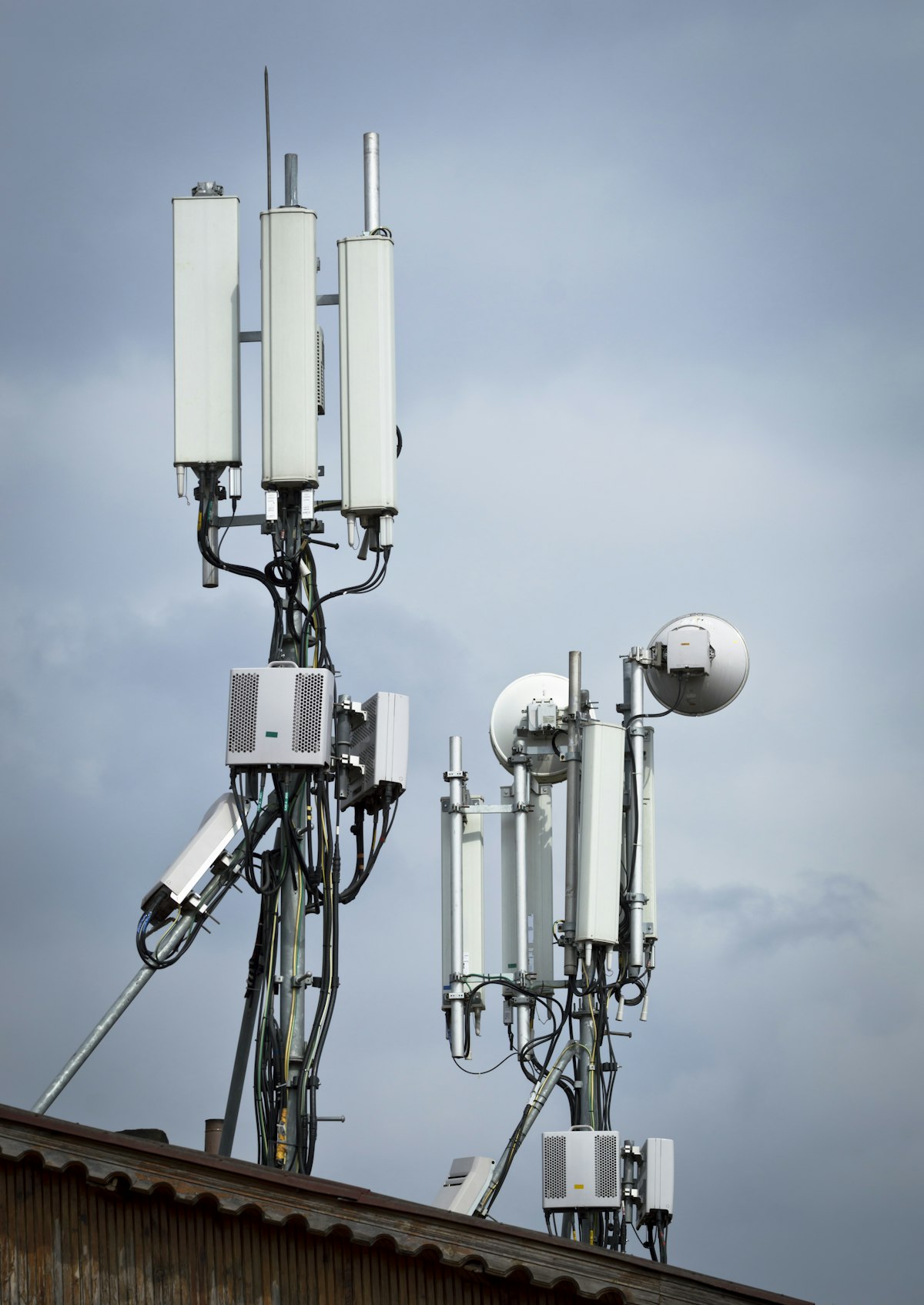 Telecommunication towers against an overcast sky